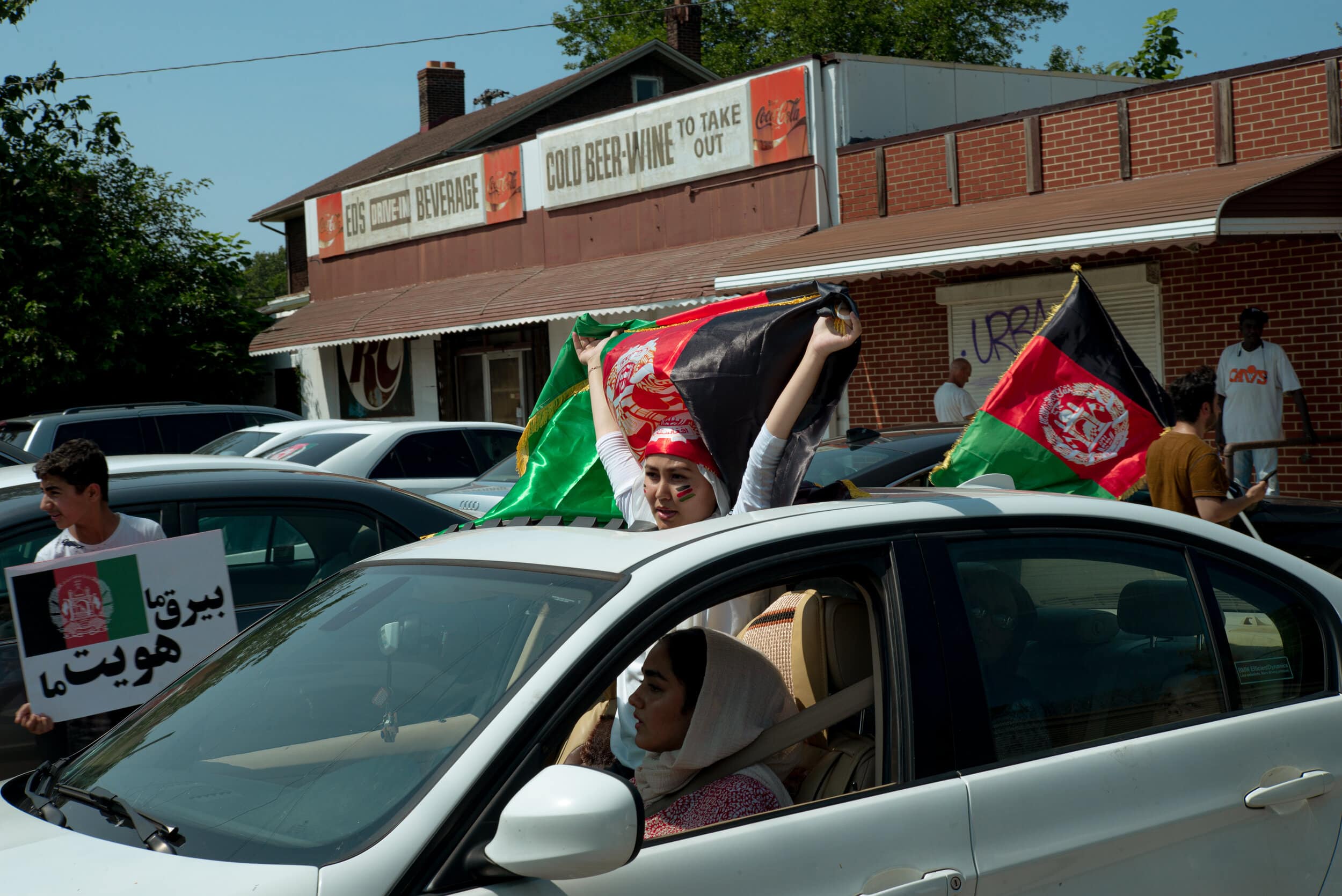 Demonstrators drive onto Detroit Avenue on Saturday, Aug. 21, 2021. Meeting originally at Masjid Mohammad Rasool Allah, Cleveland Police officers escorted a convoy demonstrators in their vehicles to a parking lot closer to the Carl B. Stokes U.S. Courthouse, which was their eventual destination. Photo by Michael Indriolo.