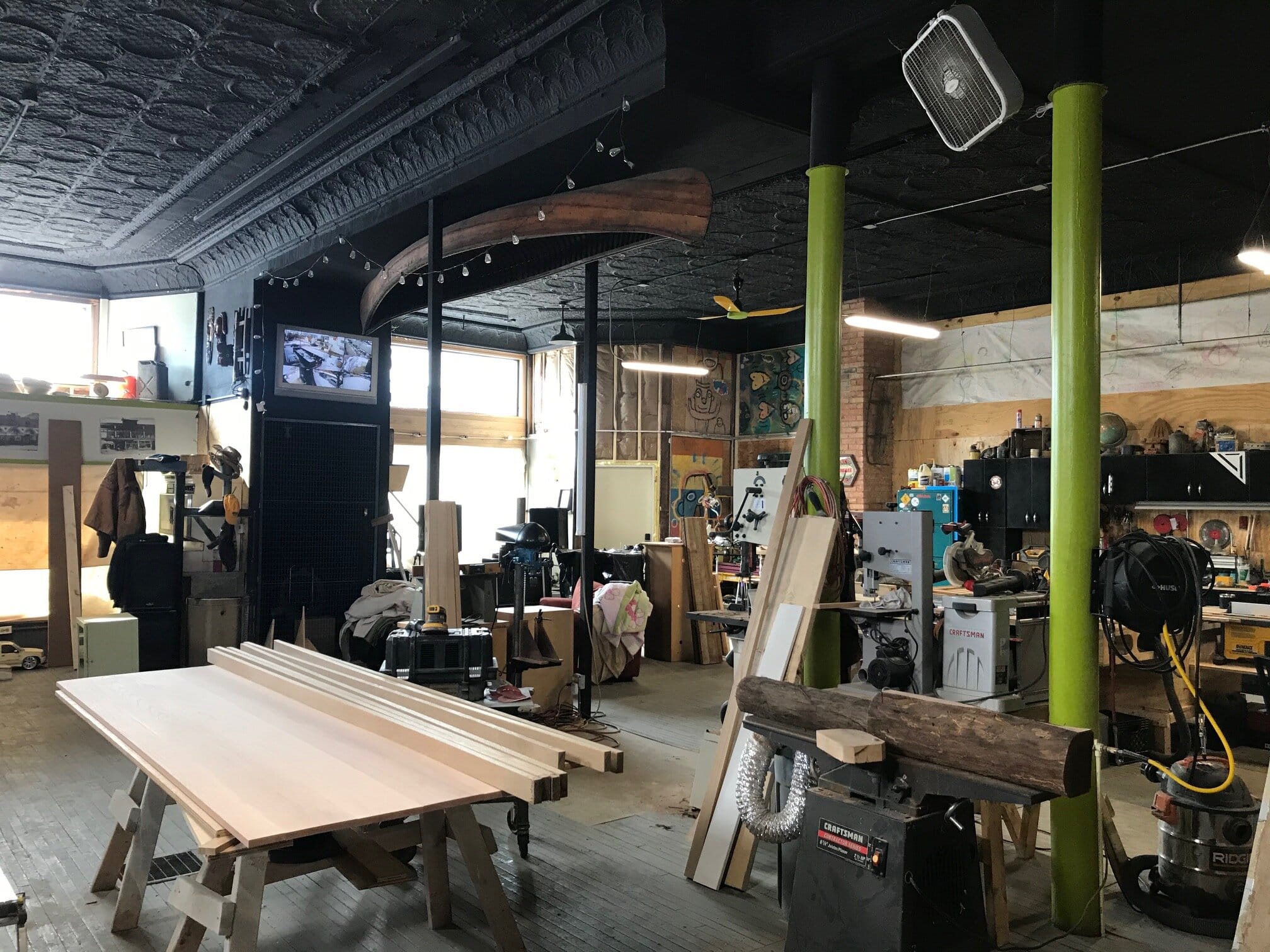 Andreoli’s workshop at 5401 Fleet Ave. includes a canoe he salvaged from the neighborhood, which he hung on the ceiling.