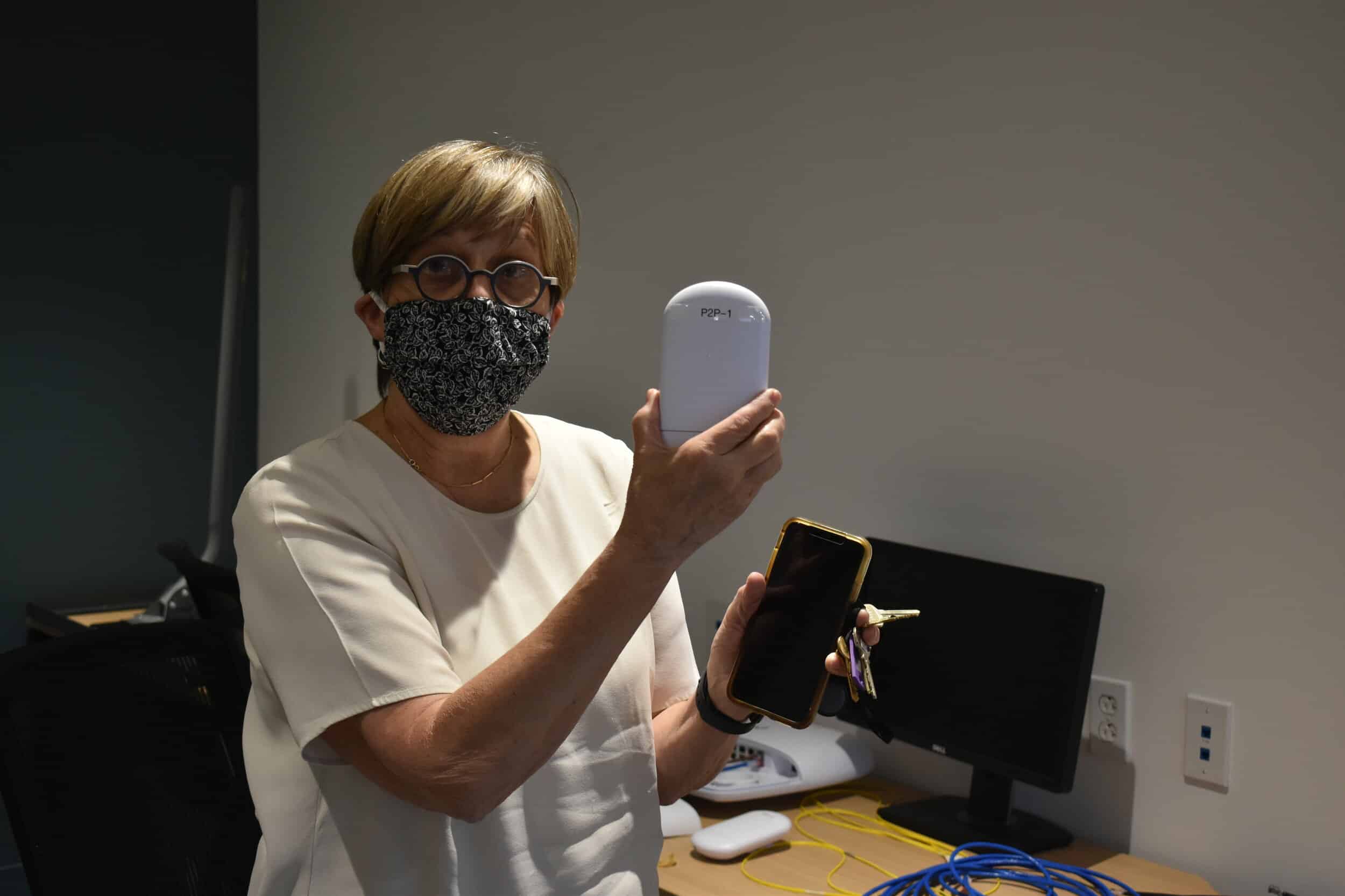 Dorothy Baunach, CEO of DigitalC, shows off a receiver device that the nonprofit uses to provide high-speed Internet to residences in neighborhoods that lack Internet access. DigitalC is attempting to get 1,000 Cleveland Metropolitan School District…