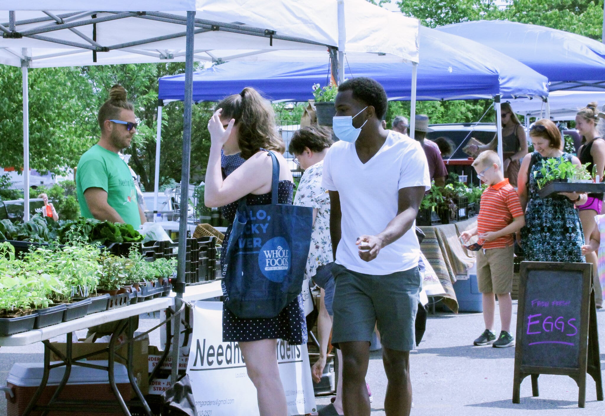 Andrew Needham, the director of Needham Gardens, sells produce at Kamm’s Corners&nbsp;Farmers&nbsp;Market&nbsp;in Cleveland’s West Park neighborhood. The open-air&nbsp;market&nbsp;remained open as an essential business during the pandemic in order to have fresh food access for residents.