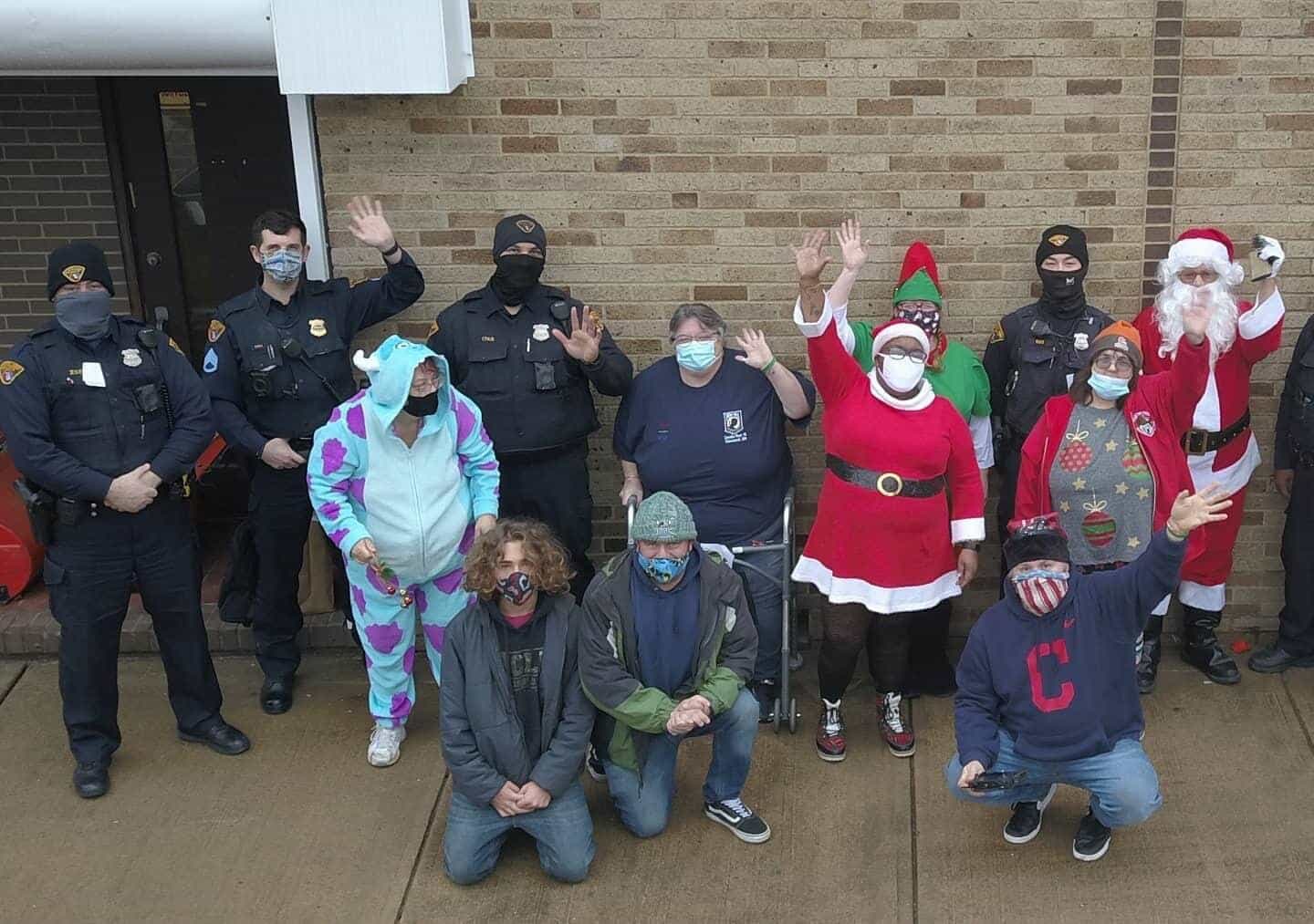Residents gather with police officers during a Christmas toy giveaway in Slavic Village.