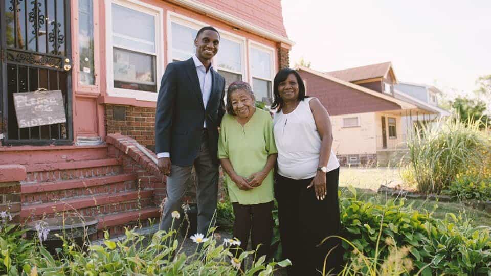Justin Bibb with his grandmother Sarah Presley and his mother Charlene standing in front of Bibb’s childhood home. (Photo/Justin Bibb for Mayor)