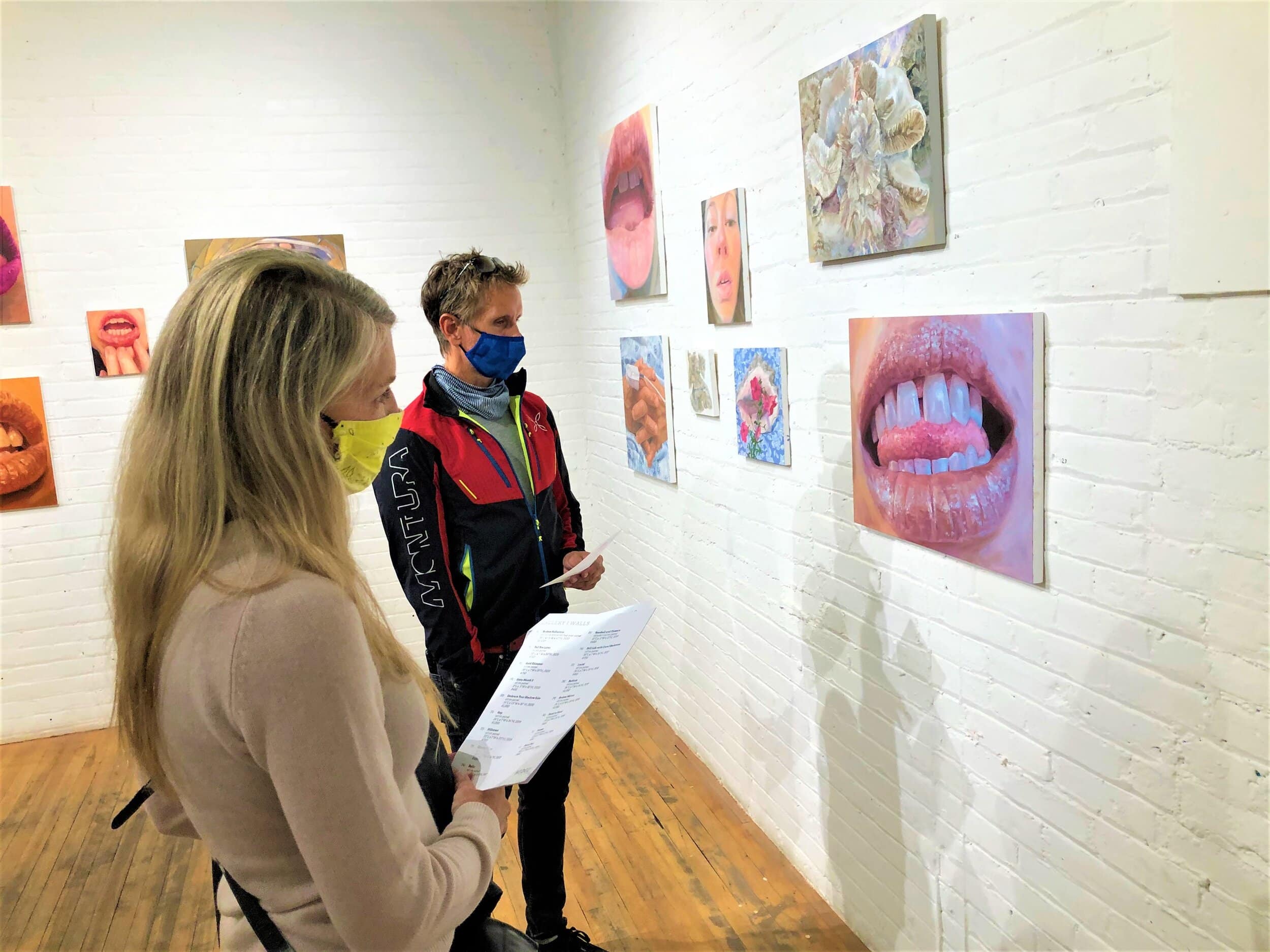 Kate and Rick Blaszak are about to buy this painting by Katy Richards at the 78th Street Studios' Hedge Gallery. Photo courtesy Grant Segall.