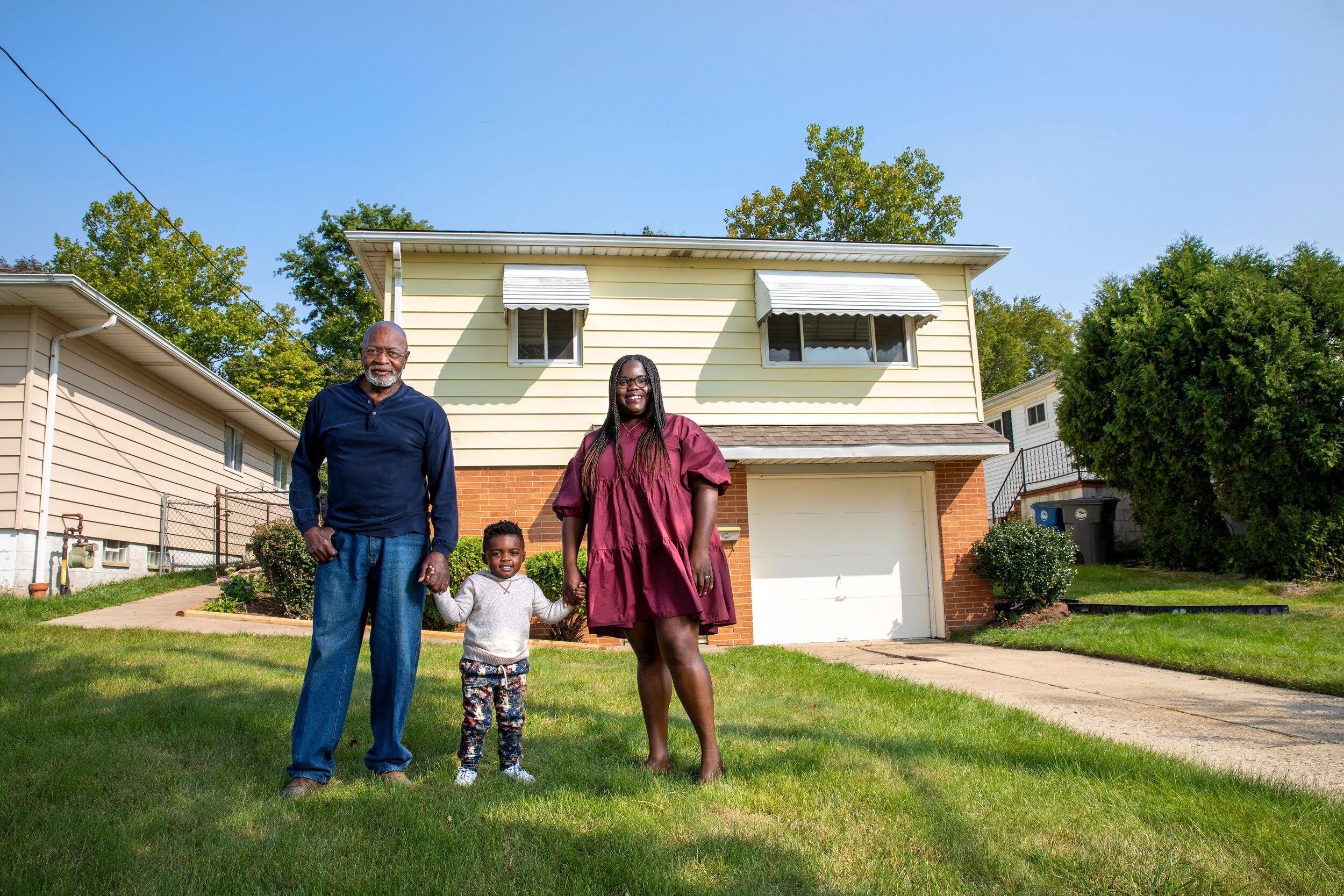 Miles Hackney, Dom Hudnall, and Leah Hudnall outside Miles' home on East 177th Street in Lee-Harvard.jpeg