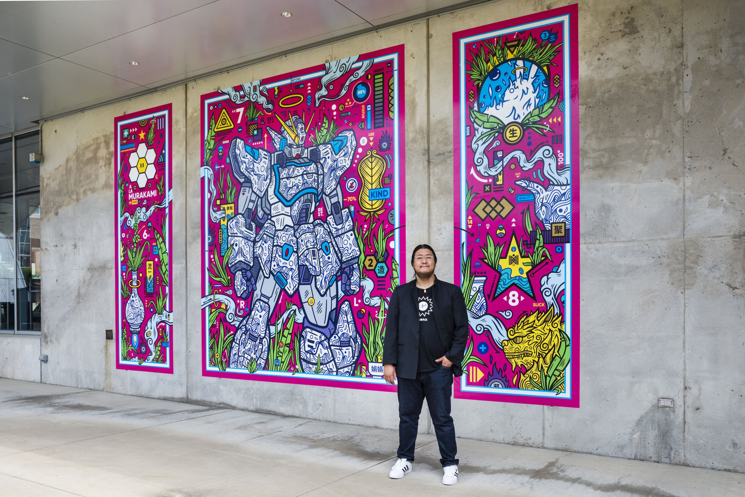 Jordan Wong standing next to “Tall Grass XLR (G. Garden)” at the Akron Art Museum’s Bud and Susie Rogers Garden. Photo by Bob Perkowski.