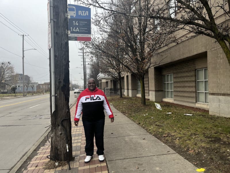 Rosie Walker standing by bus stop