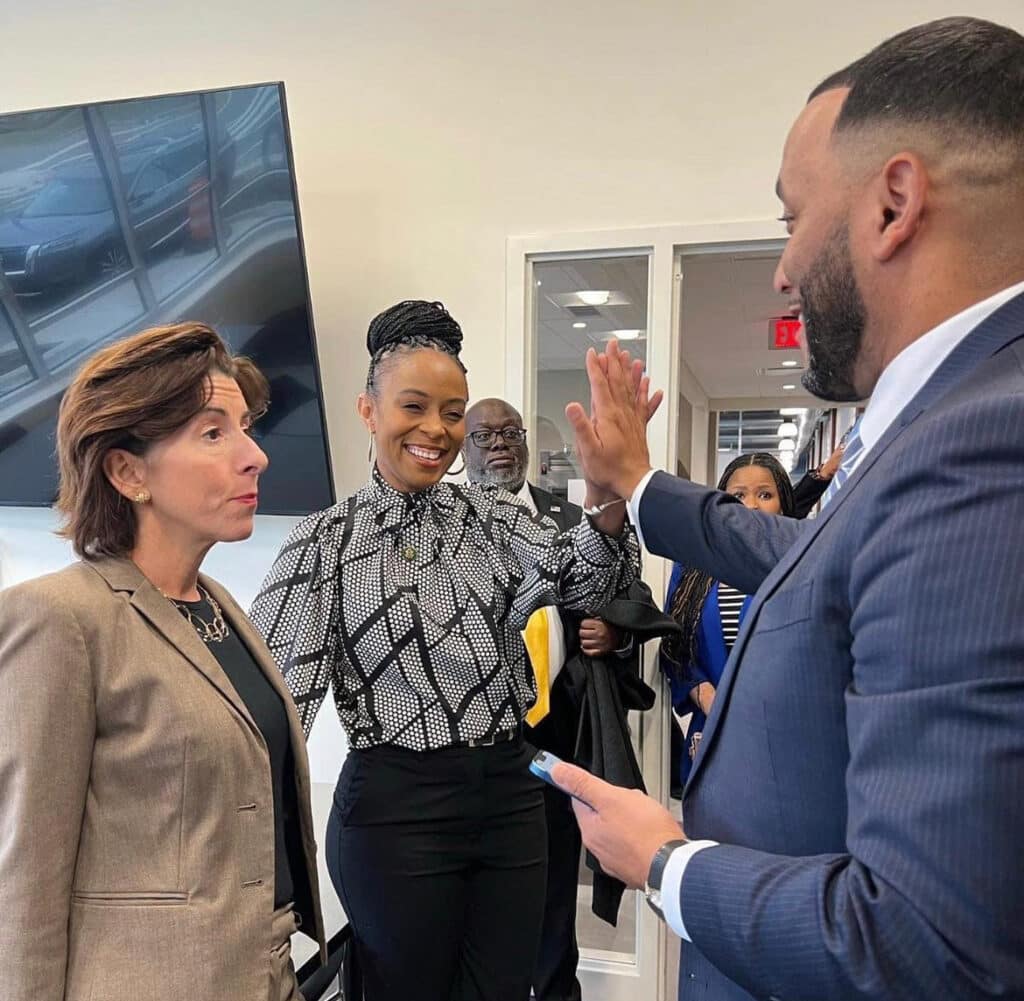 GlenVillage operations manager LaRese Purnell high-fiving Rep. Shontel Brown and talking to Secretary of Commerce Gina Raimondo.