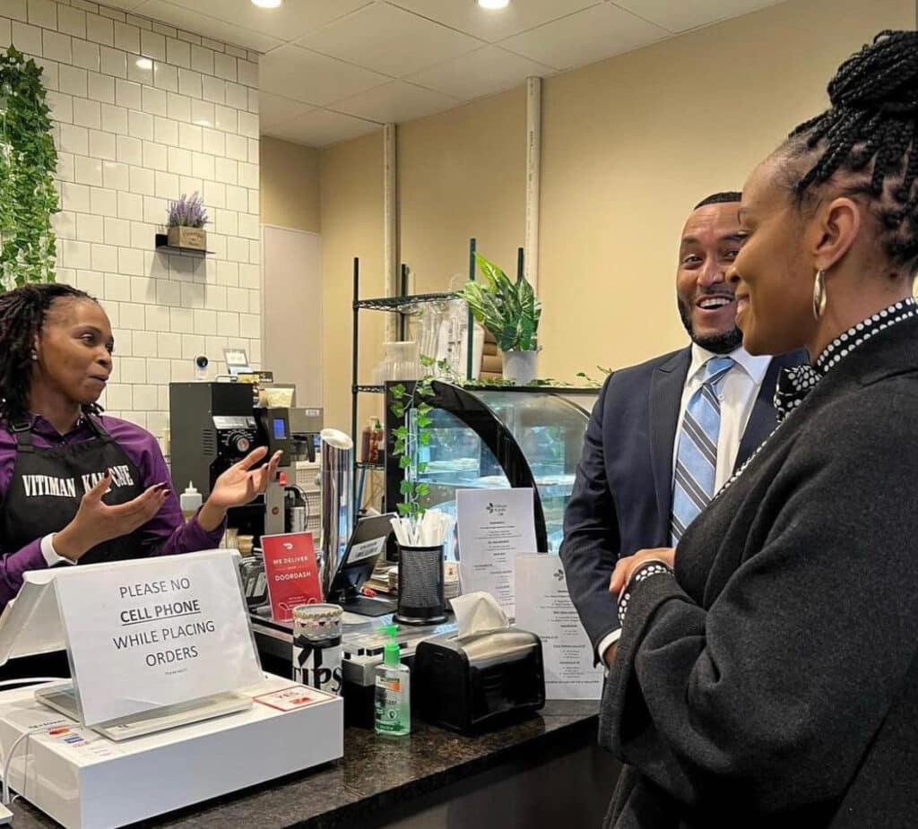 Vitiman Kandie owner Mary Johnson talking to GlenVillage operations manager LaRese Purnell and Rep. Shontel Brown