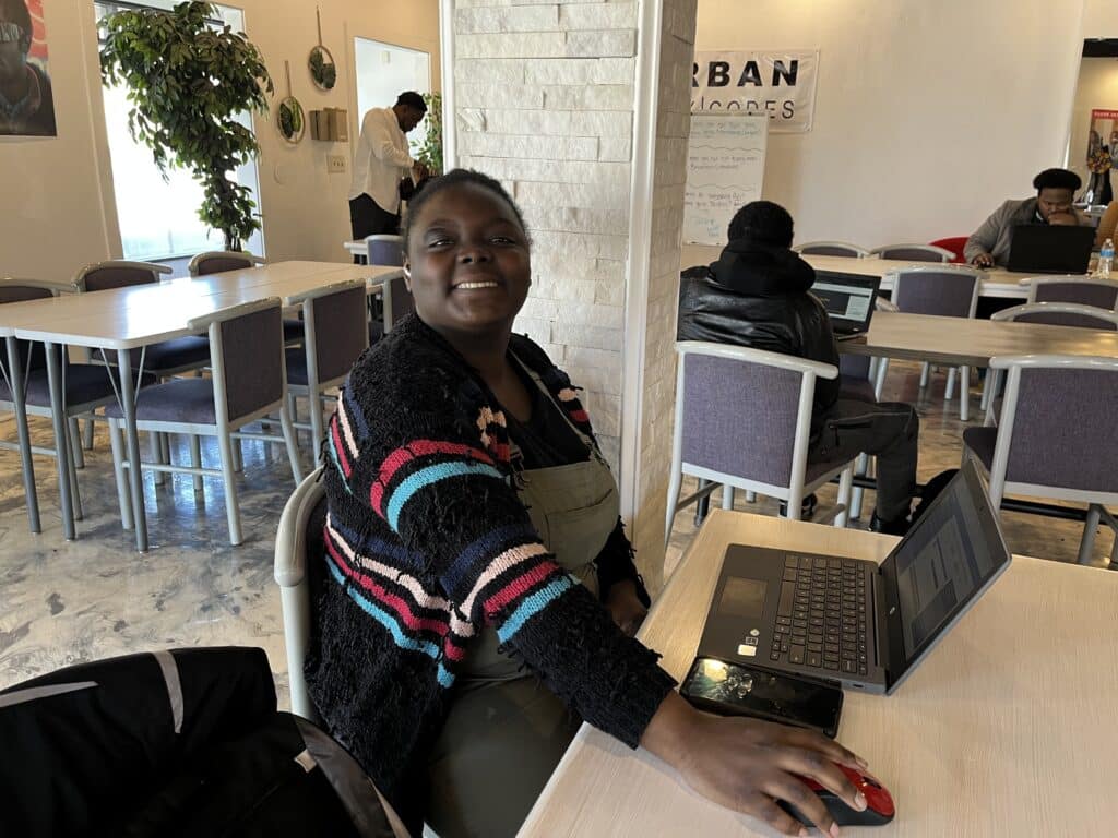 Dayuanna White pausing from working on her computer to smile for a photo. 