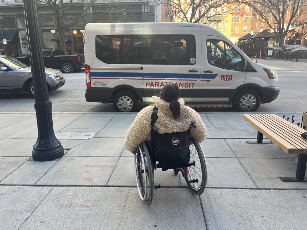 Shalida Dobbins, who uses a wheelchair, heading toward an RTA paratransit vehicle. 
