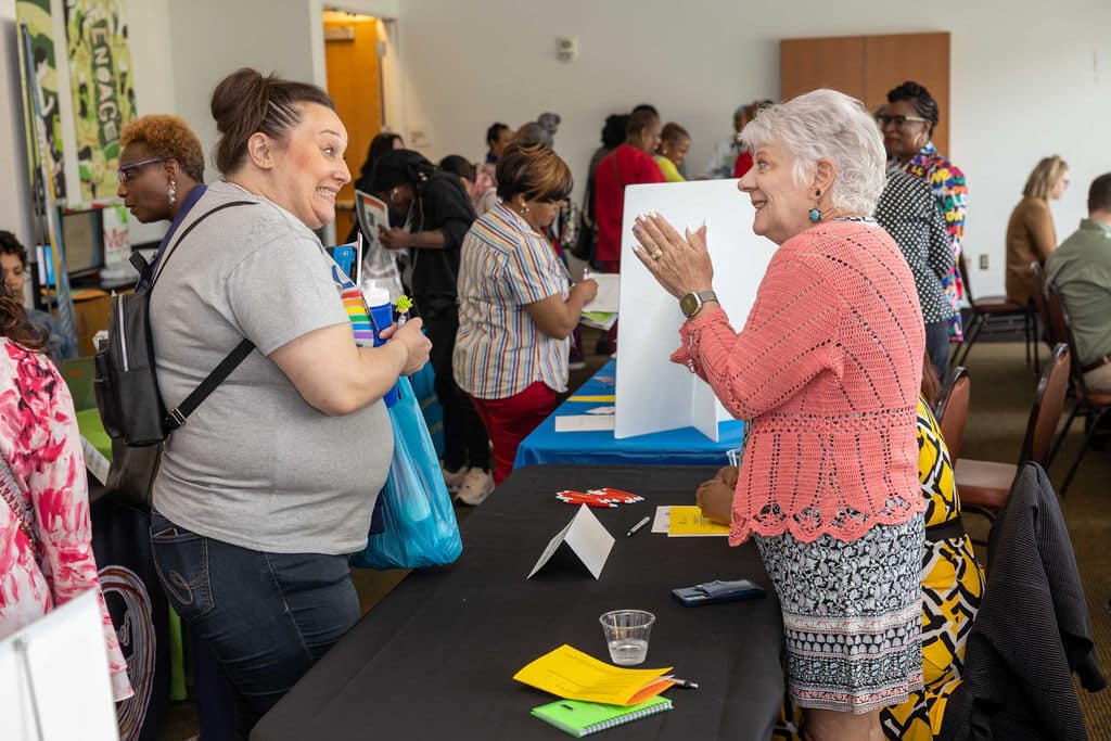 Tina Longley talking to Ginny Pate at the Community Health Worker Day event. 