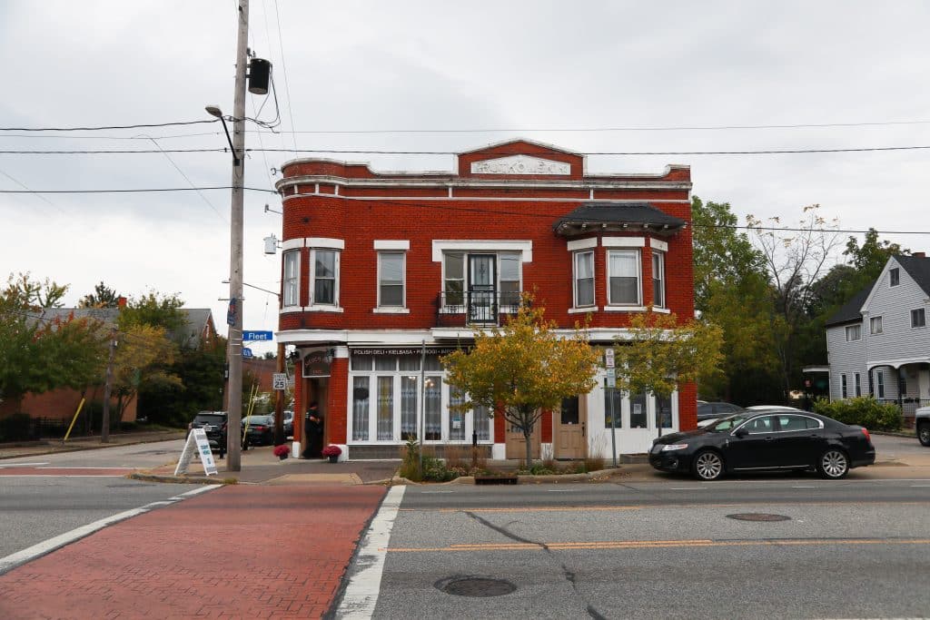 The exterior of the red brick building housing the former Seven Roses Polish Deli.