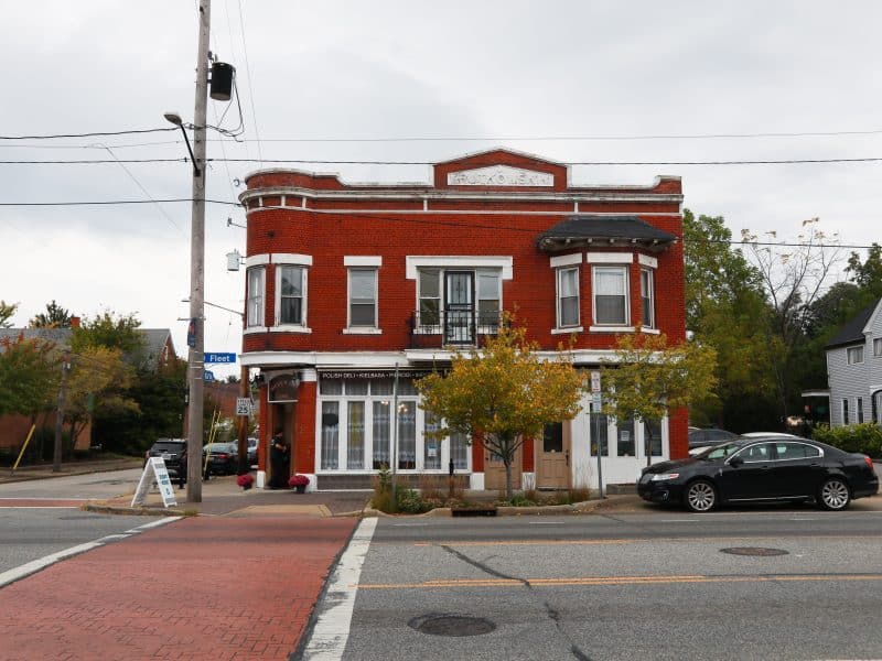 The exterior of the red brick building housing the former Seven Roses Polish Deli.