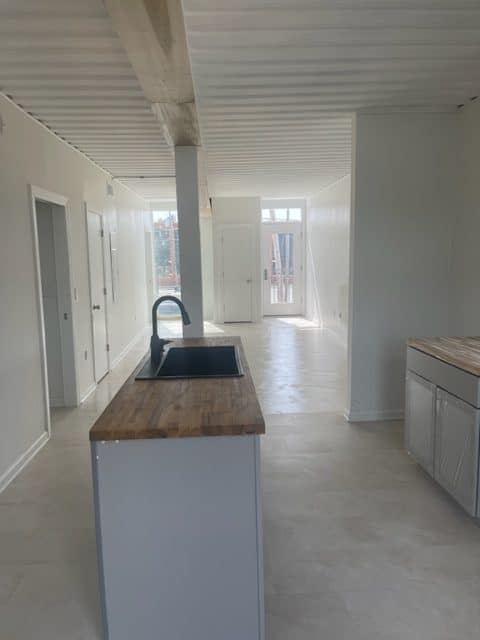 Sink and counter inside a shipping container home. 