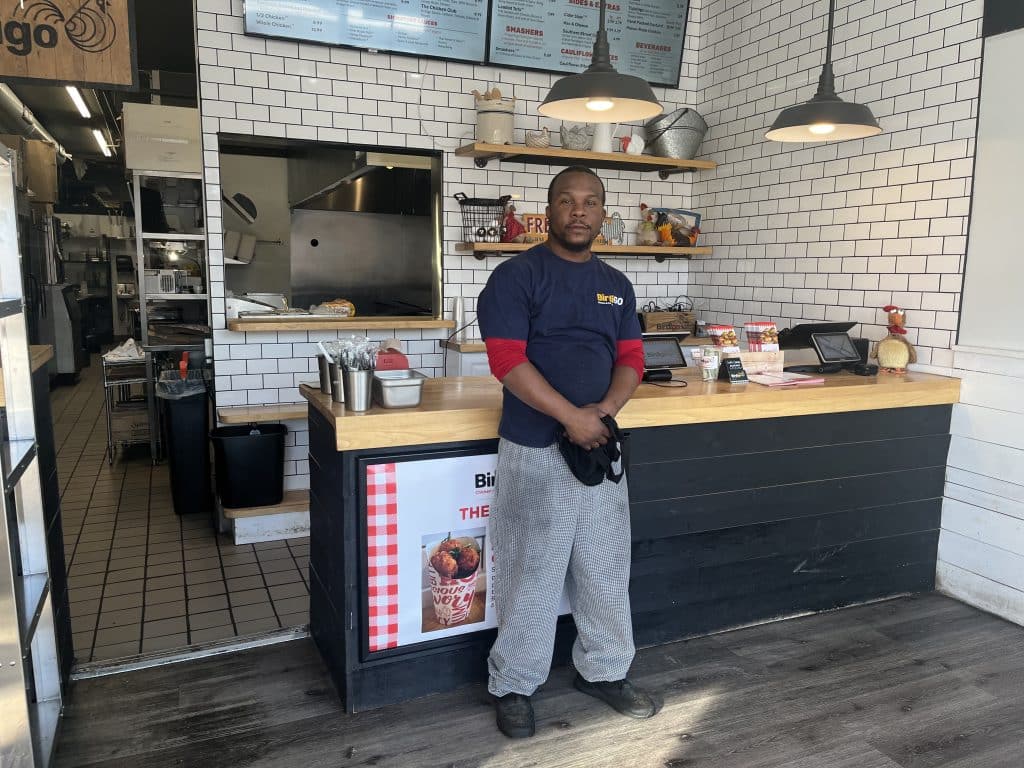Birdigo head chef Preston Holcomb standing in front of the counter at the chicken and custard restaurant in Solon. 