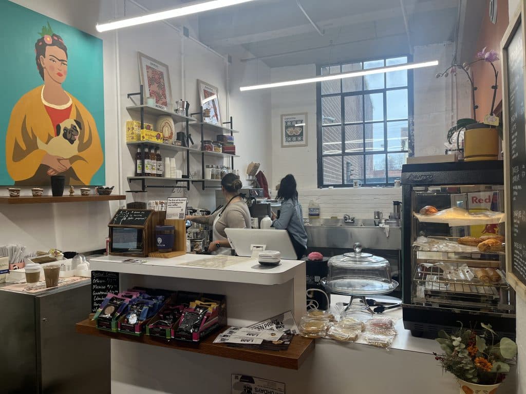 Natalia Alcazar and another Dahlia Coffee Co. employee working behind the counter at the coffee shop.