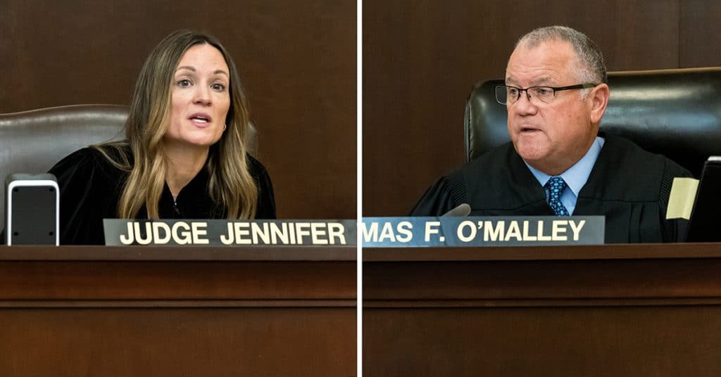 A diptych photo shows Judge Jennifer O'Malley, left, a White woman, and Judge Thomas F. O'Malley, right, a White man, in judge's robes and seated in a courtroom.