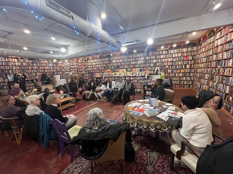 Cleveland Poet Quartez Harris speaks with group of readers during an event to re-launch his poetry collection, "We Made it to School Alive"