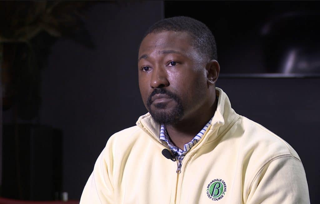 State Rep. Terrence Upchurch, a Black man, wears a pale yellow zip-up pullover during an interview with News 5 Cleveland.  